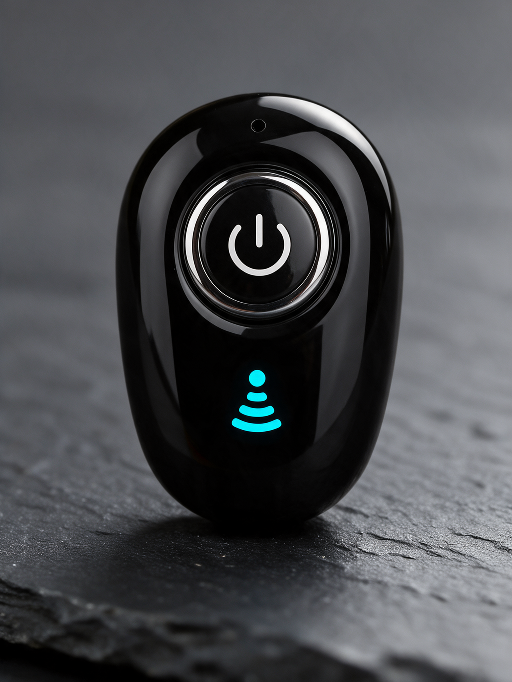 Mini Bluetooth Earpiece — close-up of the power button, microphone hole and blue indicator light