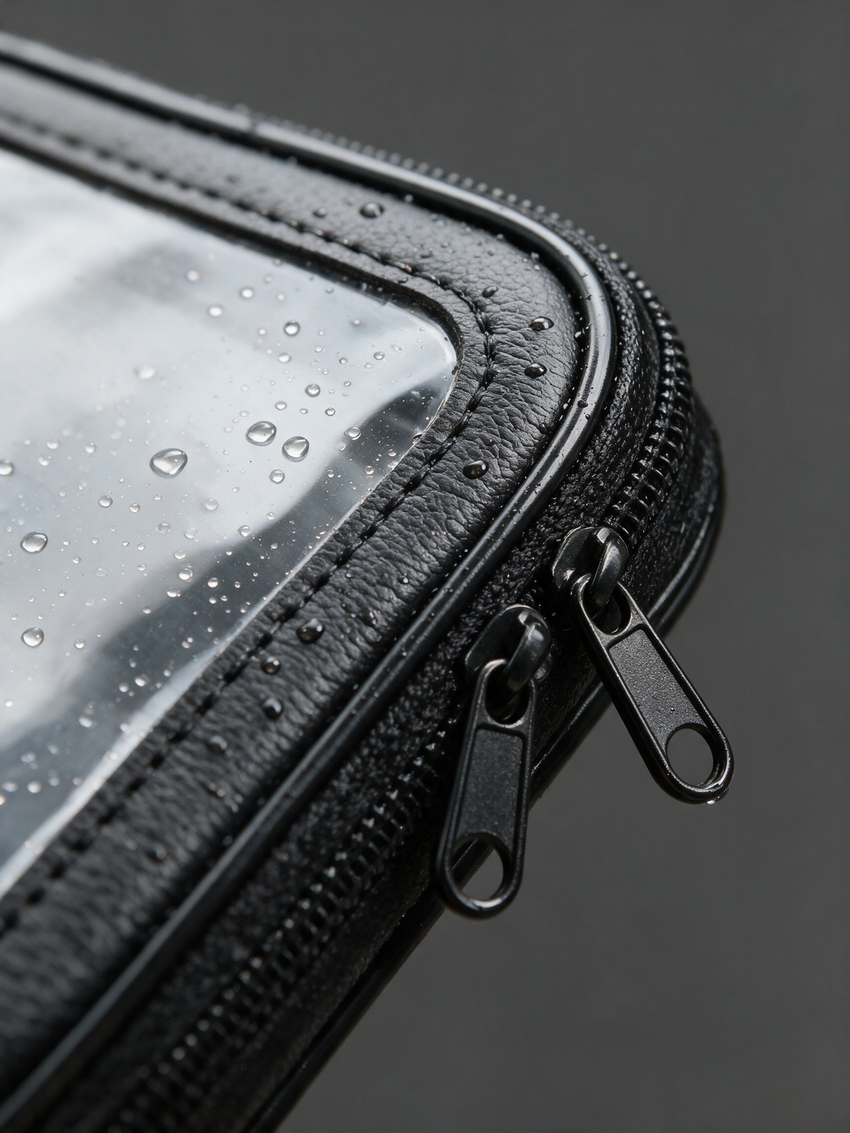 Rainproof Bike Phone Bag — close-up of the zip, stitched seam and clear window in the rain
